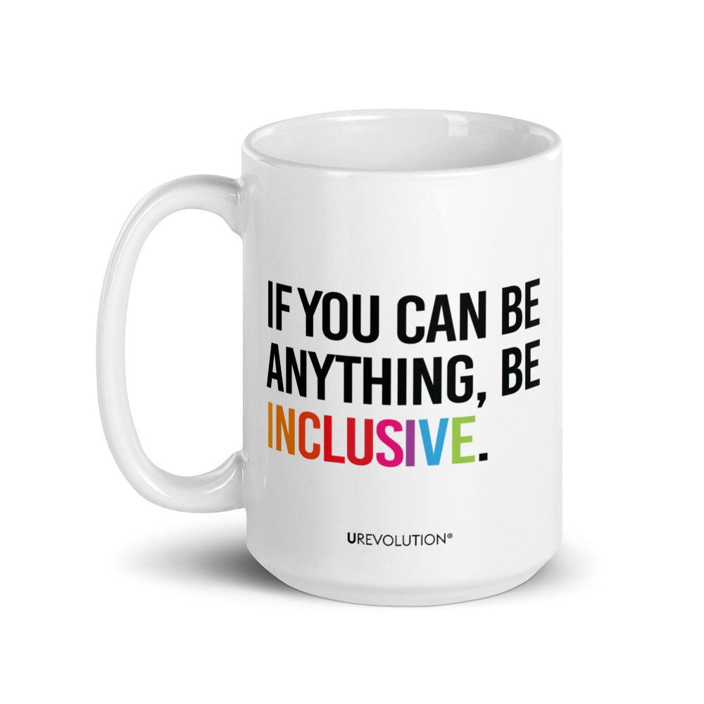 15oz Be Inclusive mug. On the right-hand side of the mug, facing the screen, is the phrase, 'If you can be anything, be inclusive,' printed in large black upper case letters. The word 'inclusive' is in the color of the rainbow. At the bottom edge of the inclusive mug is the word, URevolution, printed in small black upper case letters.