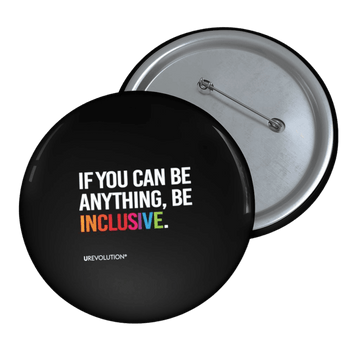 A Be Inclusive pin button. The phrase, "if you can be anything, be inclusive," is printed in upper white case letters against a black background. The word inclusive is in the colors of the rainbow.