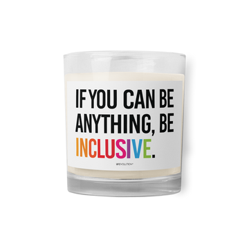 A Be Inclusive Rainbow candle. On the front of the rainbow candle is the phrase: "If you can be anything, be inclusive," in upper case letters printed on a white label. The text is all black, except the word "Inclusive," which is in the colors of the rainbow.