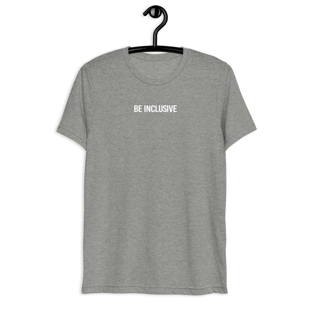 Athletic grey unisex tri-blend Be Inclusive t-shirt. Printed in the middle top one-third of the t-shirt in white upper case letters, about one inch high is the phrase - Be Inclusive. The t-shirt is hanging on a black plastic hanger against a blank wall.