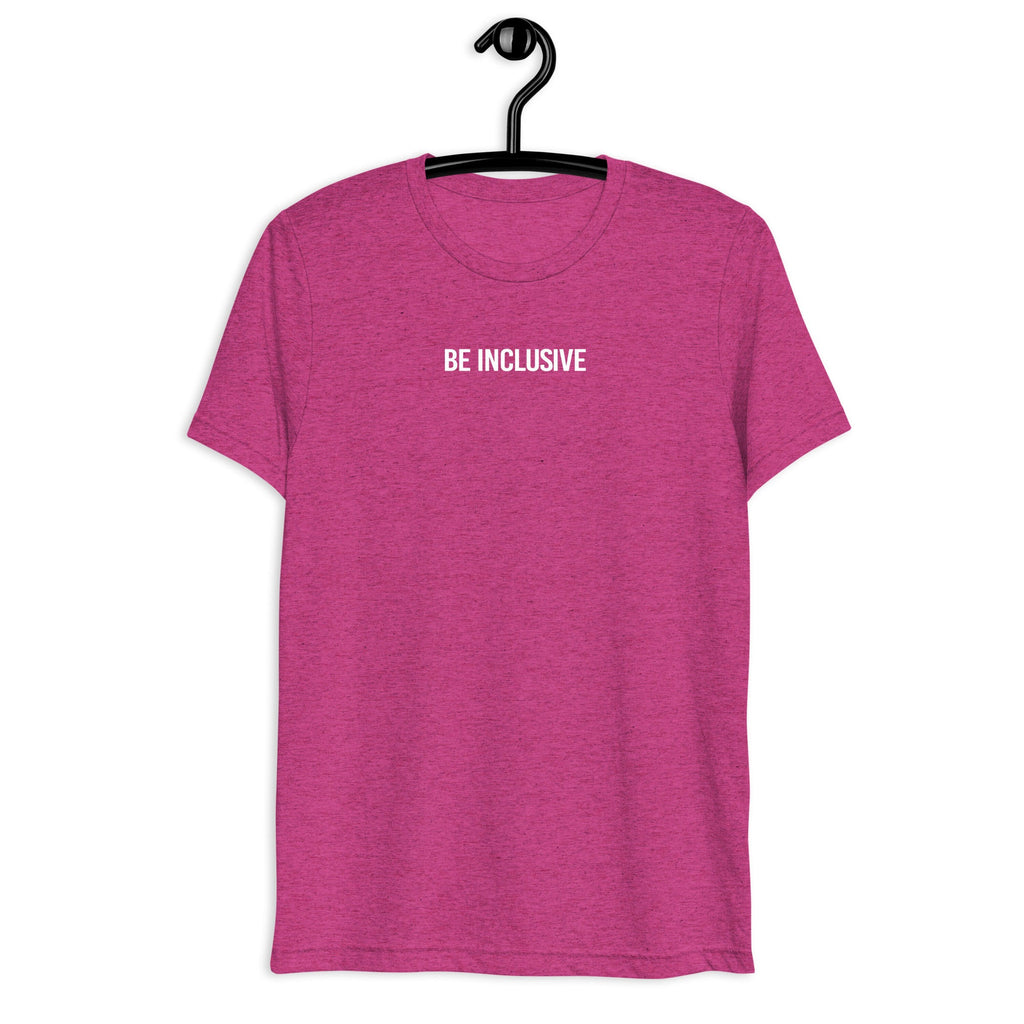 Berry unisex tri-blend Be Inclusive t-shirt. Printed in the middle top one-third of the t-shirt in white upper case letters, about one inch high is the phrase - Be Inclusive. The t-shirt is hanging on a black plastic hanger against a blank wall.