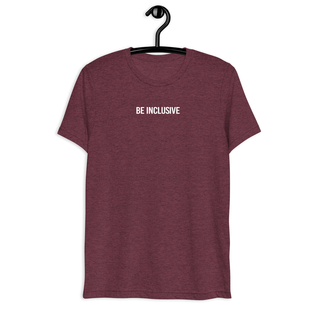 Maroon unisex tri-blend Be Inclusive t-shirt. Printed in the middle top one-third of the t-shirt in white upper case letters, about one inch high is the phrase - Be Inclusive. The t-shirt is hanging on a black plastic hanger against a blank wall.