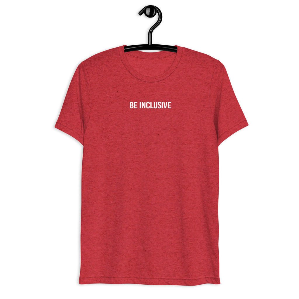 Red unisex tri-blend Be Inclusive t-shirt. Printed in the middle top one-third of the t-shirt in white upper case letters, about one inch high is the phrase - Be Inclusive. The t-shirt is hanging on a black plastic hanger against a blank wall.