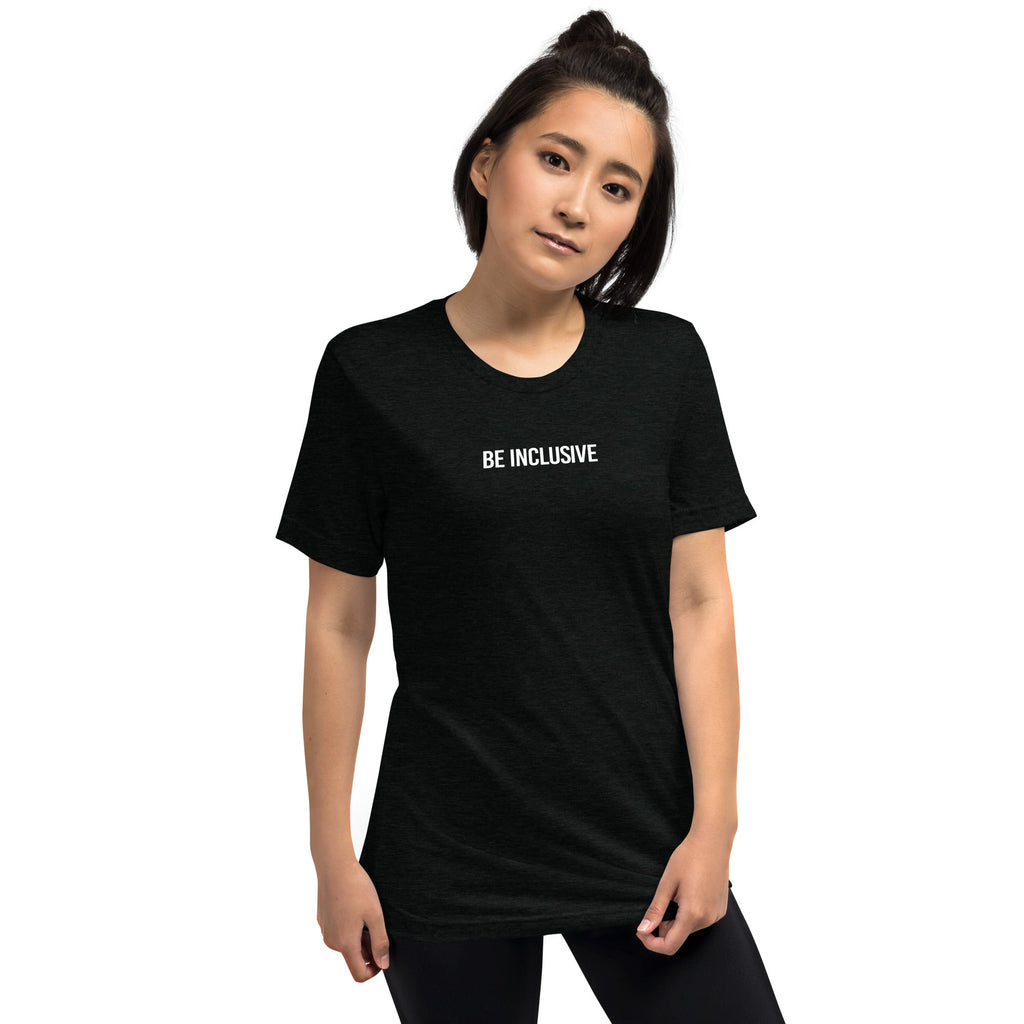 This is a photo of a unisex tri-blend Be Inclusive t-shirt worn by a model. Printed in the middle top one-third of the t-shirt in white upper case letters, about one inch high is the phrase - Be Inclusive. 