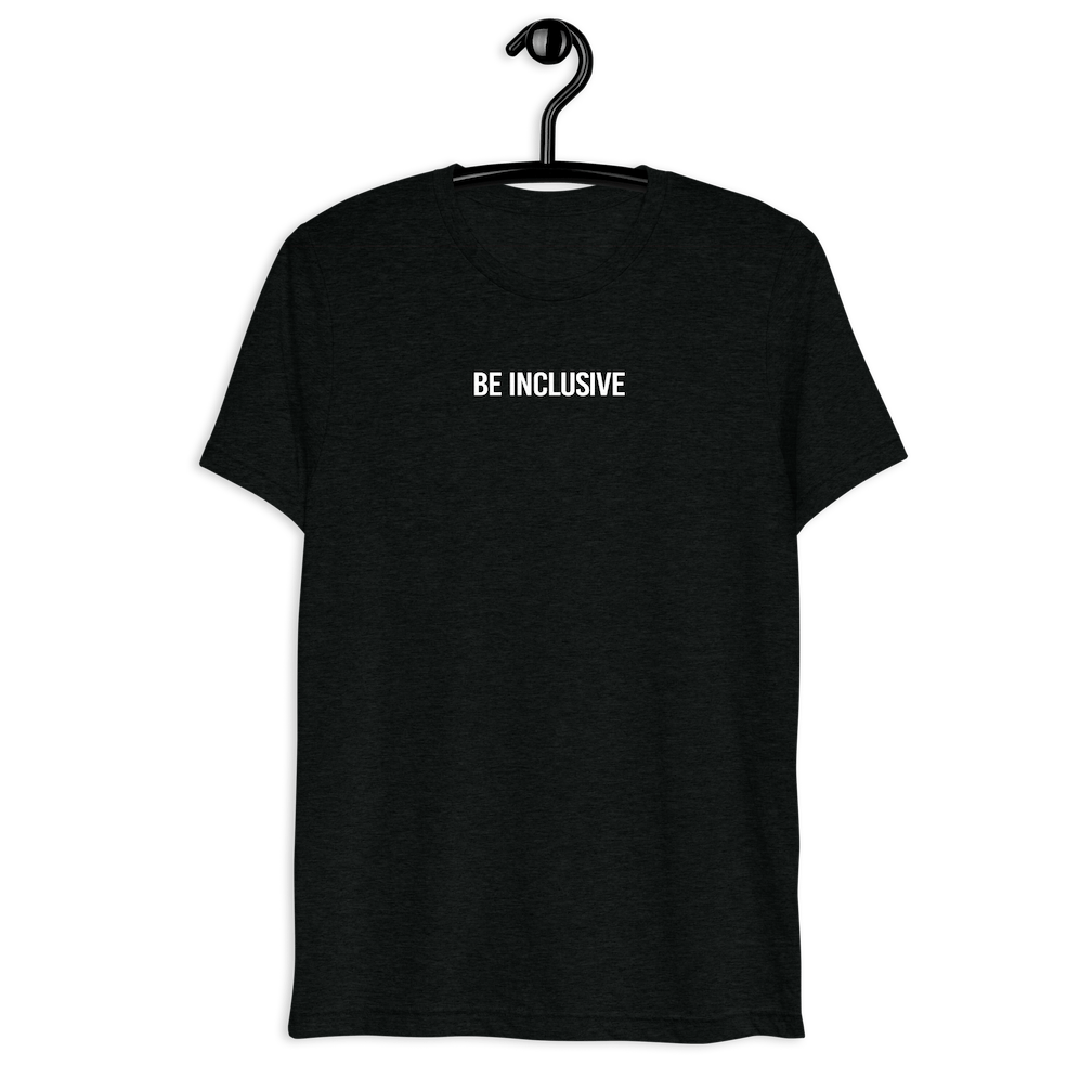 unisex tri-blend Be Inclusive t-shirt. Printed in the middle top one-third of the t-shirt in white upper case letters, about one inch high is the phrase - Be Inclusive.  The t-shirt is hanging on a black plastic hanger against a blank wall.
