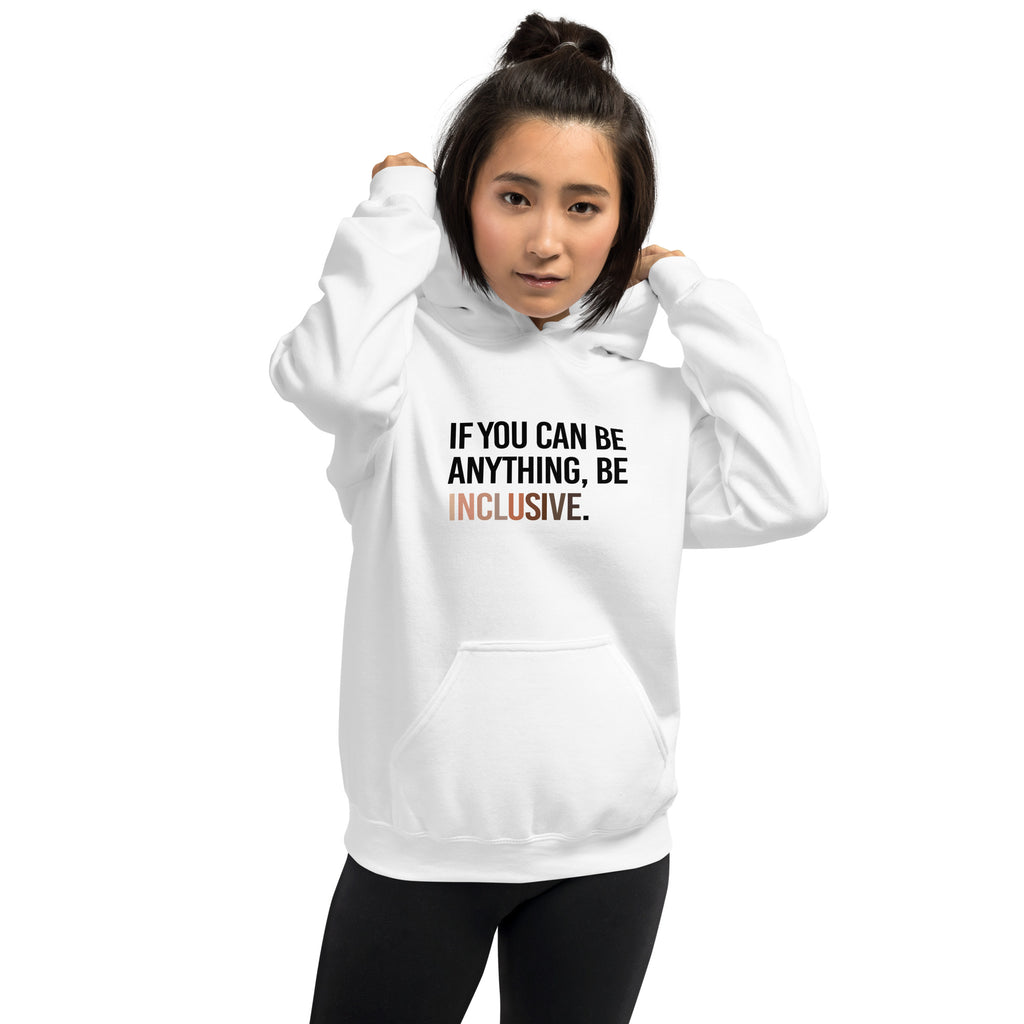 A photo of a white Be Inclusive Diversity Hoodie promoting racial diversity. On the front of the diversity hoodie is the phrase: "If you can be anything, be inclusive," in black upper case letters. The text is all black, except the word "Inclusive," which is in different skin colors, with the lightest color on the left and the darkest on the right. A woman with short black hair is wearing the hoodie.
