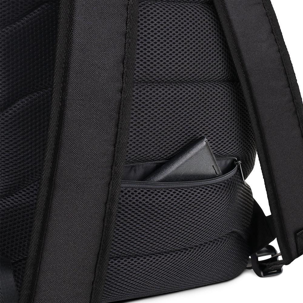 A close up of the padded back of the backpack. At the bottom edge of the backpack is a hidden pocket showing a wallet.