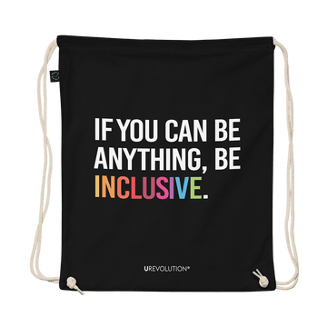 This is a photo of URevolution's black Be Inclusive organic cotton drawstring bag. In the middle of the drawstring bag, printed in large white upper case letters, is the phrase, 'If you can be anything, be inclusive.' The word 'inclusive' is in the color of the rainbow. At the bottom edge of the bag is the word, URevolution, printed in small white upper case letters.