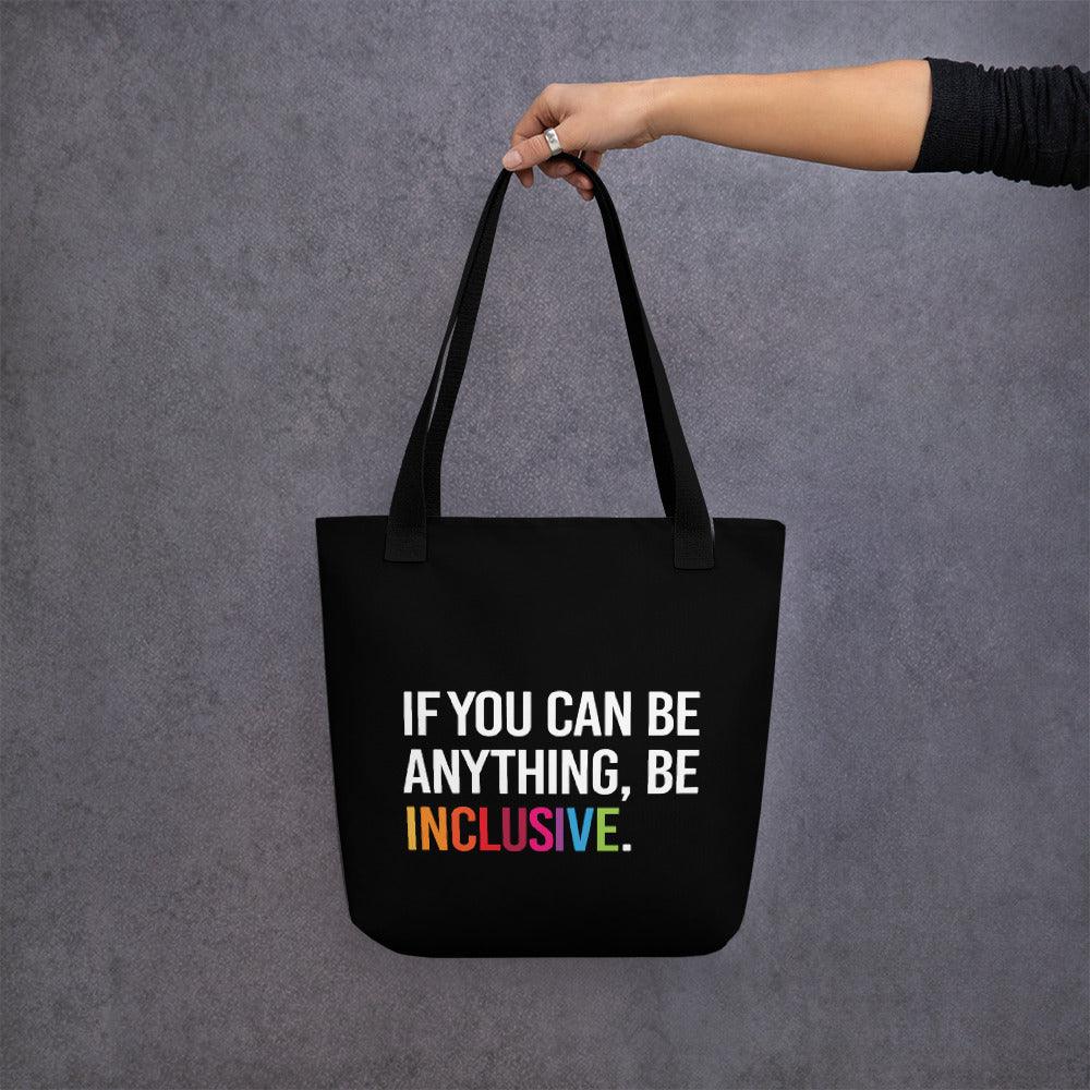 Inclusive Tote Bag. The black tote has the phrase, 'If you can be anything, Be Inclusive,' printed in white. The word inclusive is in the colors of the rainbow.