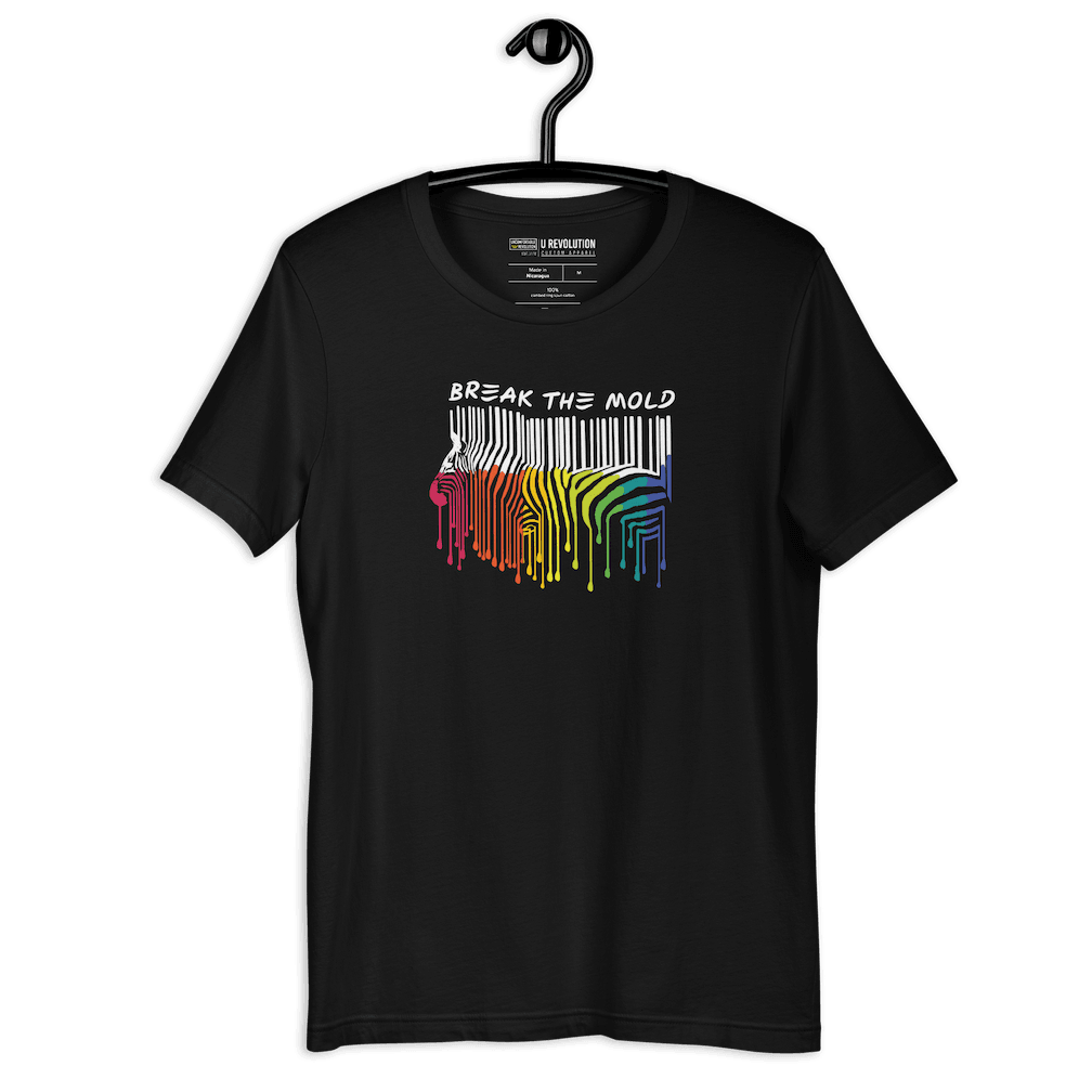 This is a photo of a Break the Mold t-shirt. In the middle of the t-shirt is a graphic of zebra in the silhouette of a barcode. The top half of the zebra are vertical white stripes, which then change just below the back into the colors of the rainbow. The bottom of each stripe has a paint drip mark. Just above the zebra's back is the phrase, in upper case, 'break the mold.' 