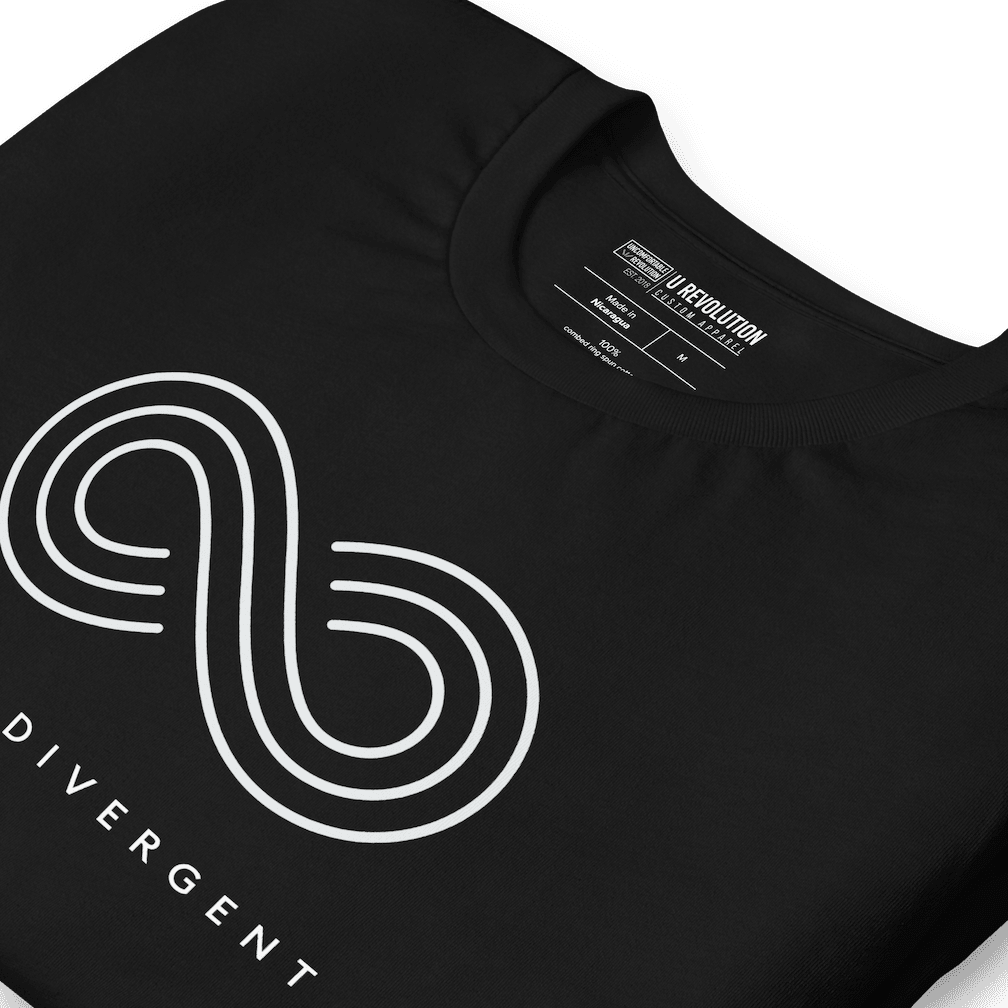 Black neurodivergent shirt against a plain background. In the top 1/3 of the neurodivergent shirt is an elegant white infinity symbol consisting of three thin white lines. Just below the infinity symbol is the word Neurodivergent in elegant upper case white letters.