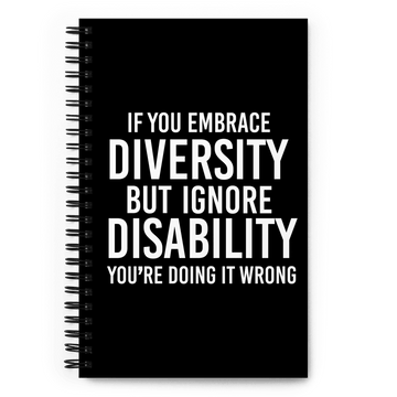 Front cover of URevolution's spiral-bound black Embrace Diversity notebook. The cover features URevolution's original Embrace Diversity phrase printed in white on a black background: "If you embrace diversity but ignore disability, you're doing it wrong."