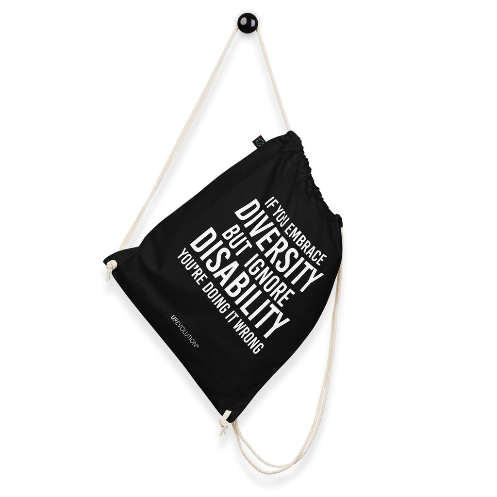 A black Embrace Diversity organic cotton drawstring bag. The middle of the drawstring bag features the phrase, printed in large white upper case letters, "If you embrace diversity but ignore disability, you're doing it wrong." The phrase fills 80% of the bag. 