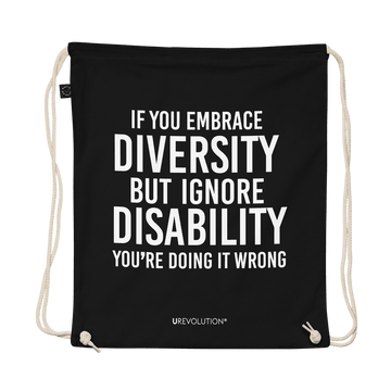 A black Embrace Diversity organic cotton drawstring bag. The middle of the drawstring bag features the phrase, printed in large white upper case letters, "If you embrace diversity but ignore disability, you're doing it wrong." The phrase fills 80% of the bag. 