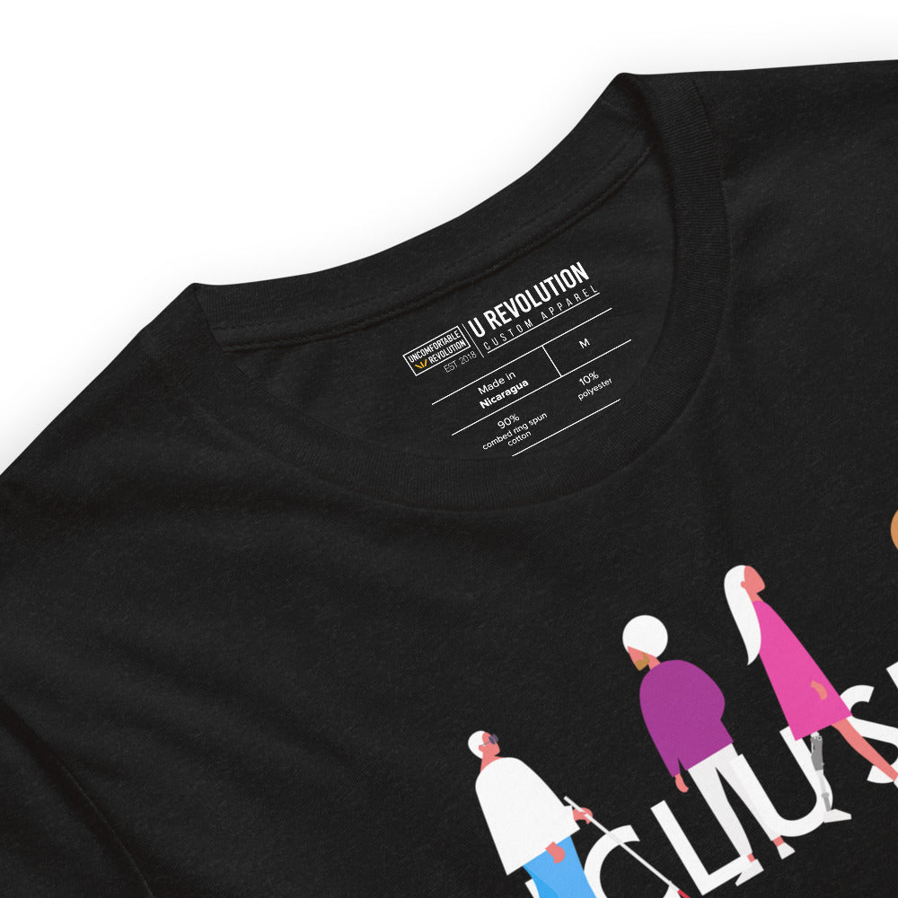 Front view of a Black Heather URevolution inclusion tee featuring their original Inclusion icon: The word INCLUSION is written in white upper case letters. Among the letters are four characters: one larger person with glasses and a cane, one person with one arm wearing a turban, one person with long hair and a prosthetic leg, and one person with an afro, seated in a wheelchair leaning forward. 