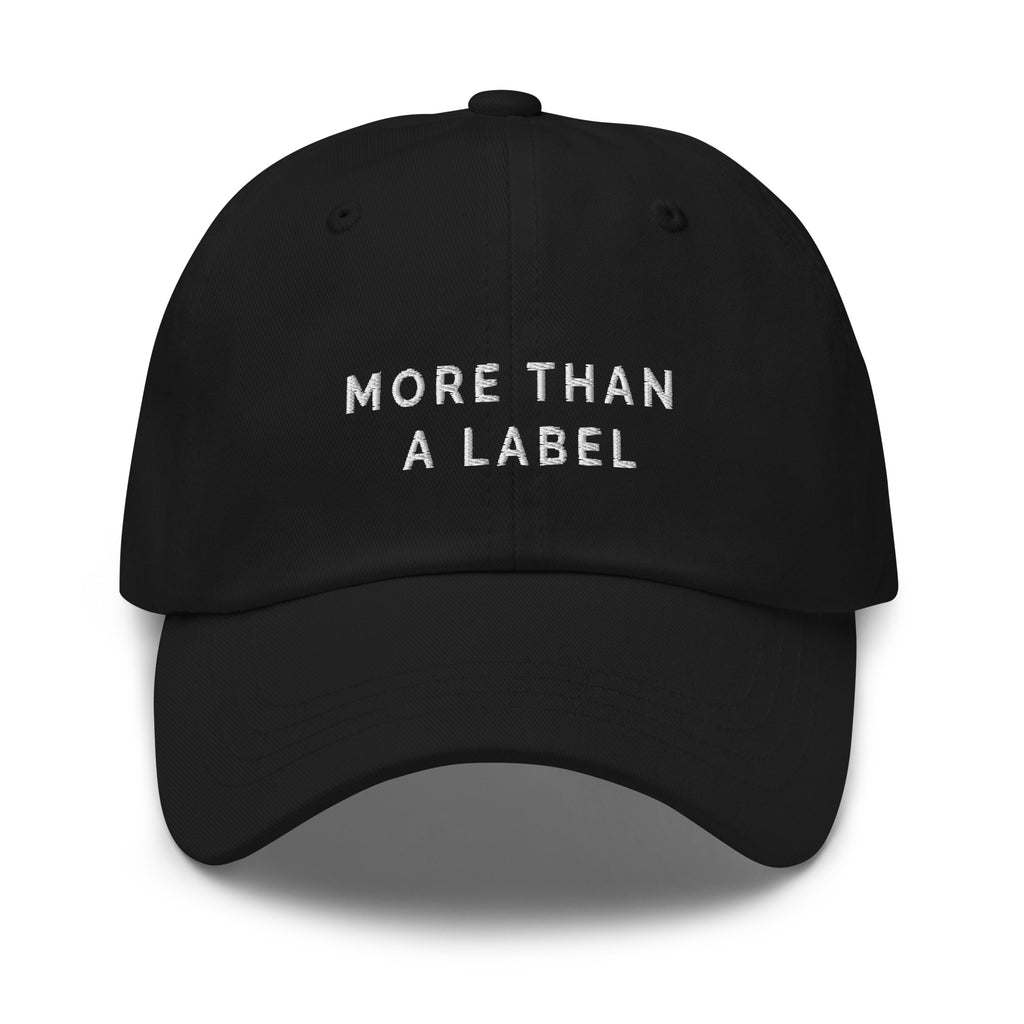 A black More Than A Label cap. In the middle of the cap is the phrase, 'More Than A Label,' embroidered in white upper case letters.