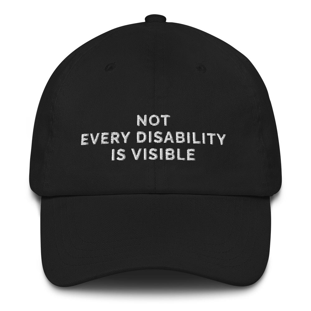This is a photo of a black 'not every disability is visible' cap. Embroidered, on the front of the cap in white upper case letters, is the phrase 'Not Every Disability Is Visible.'