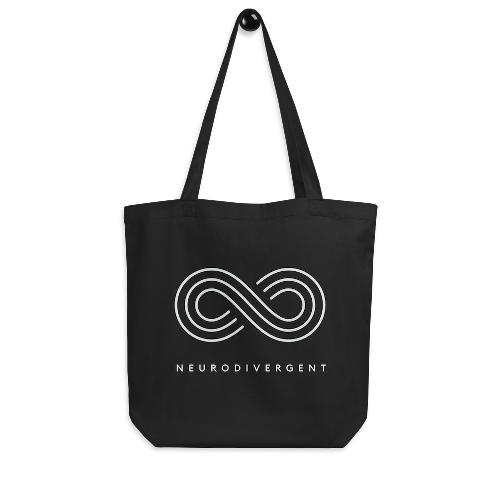 This is a photo of a black organic neurodivergent tote bag. In the middle of the tote is an elegant white infinity symbol consisting of three thin white lines. Just below the infinity symbol is the word Neurodivergent in elegant upper case white letters.