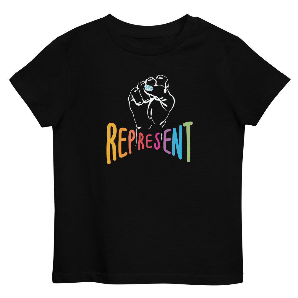 Photo of an organic kids black Represent tee. In the center of the organic tee is a white drawing of a raised clenched fist, with the handwritten word “represent,” written in upper case rainbow colors beneath the fist.