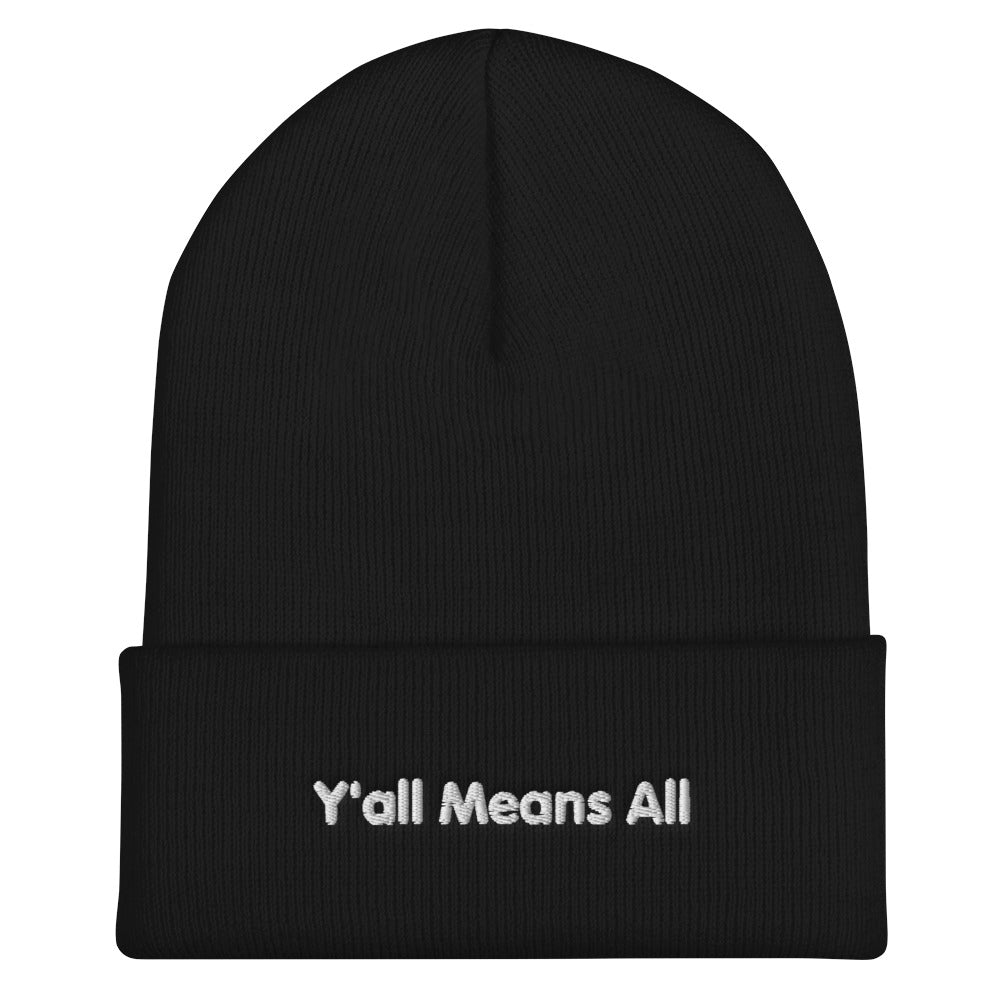 This is a photo of a black-colored Y'all Means All beanie. On the front of the beanie the phrase, 'Y'all Means All,' is embroidered on it in white title case letters.