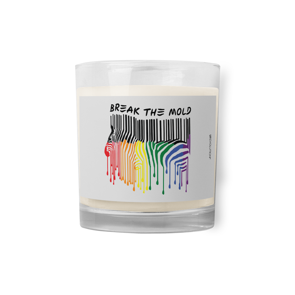 Break The Mold soy wax candle. In the middle of the candle is a zebra graphic in the silhouette of a barcode. The top half of the zebra are vertical black stripes, which change just below the back into the colors of the rainbow. The bottom of each strip has a paint drip mark. Above the zebra's back is the phrase, in upper case, 'break the mold.' 