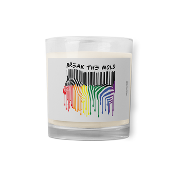 Break The Mold soy wax candle. In the middle of the candle is a zebra graphic in the silhouette of a barcode. The top half of the zebra are vertical black stripes, which change just below the back into the colors of the rainbow. The bottom of each strip has a paint drip mark. Above the zebra's back is the phrase, in upper case, 'break the mold.' 