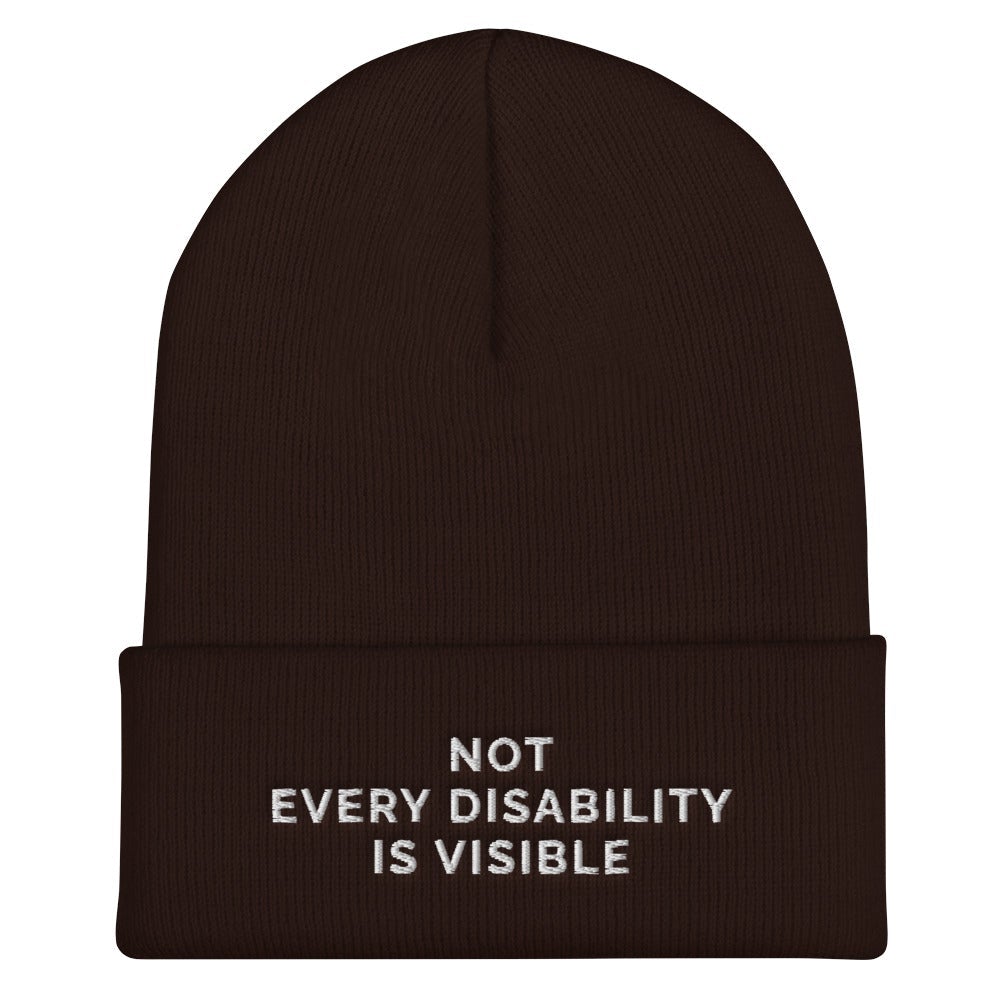 Beanie Inspo - a photo of a brown hypoallergenic Not Every Disability Is Visible Beanie lying flat against a plain background. On the cuff of the beanie the phrase, 'Not Every Disability Is Visible,' is embroidered on it over three lines in white upper case letters. 