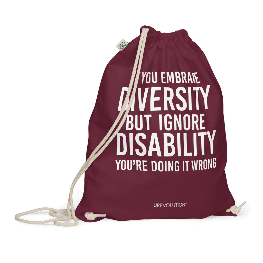 A burgundy Embrace Diversity organic cotton drawstring bag. The middle of the drawstring bag features the phrase, printed in large white upper case letters, "If you embrace diversity but ignore disability, you're doing it wrong." The phrase fills 80% of the bag. 