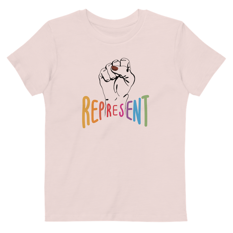 Photo of an organic kids candy pink Represent tee. In the center of the organic tee is a black drawing of a raised clenched fist, with the handwritten word “represent,” written in upper case rainbow colors beneath the fist.