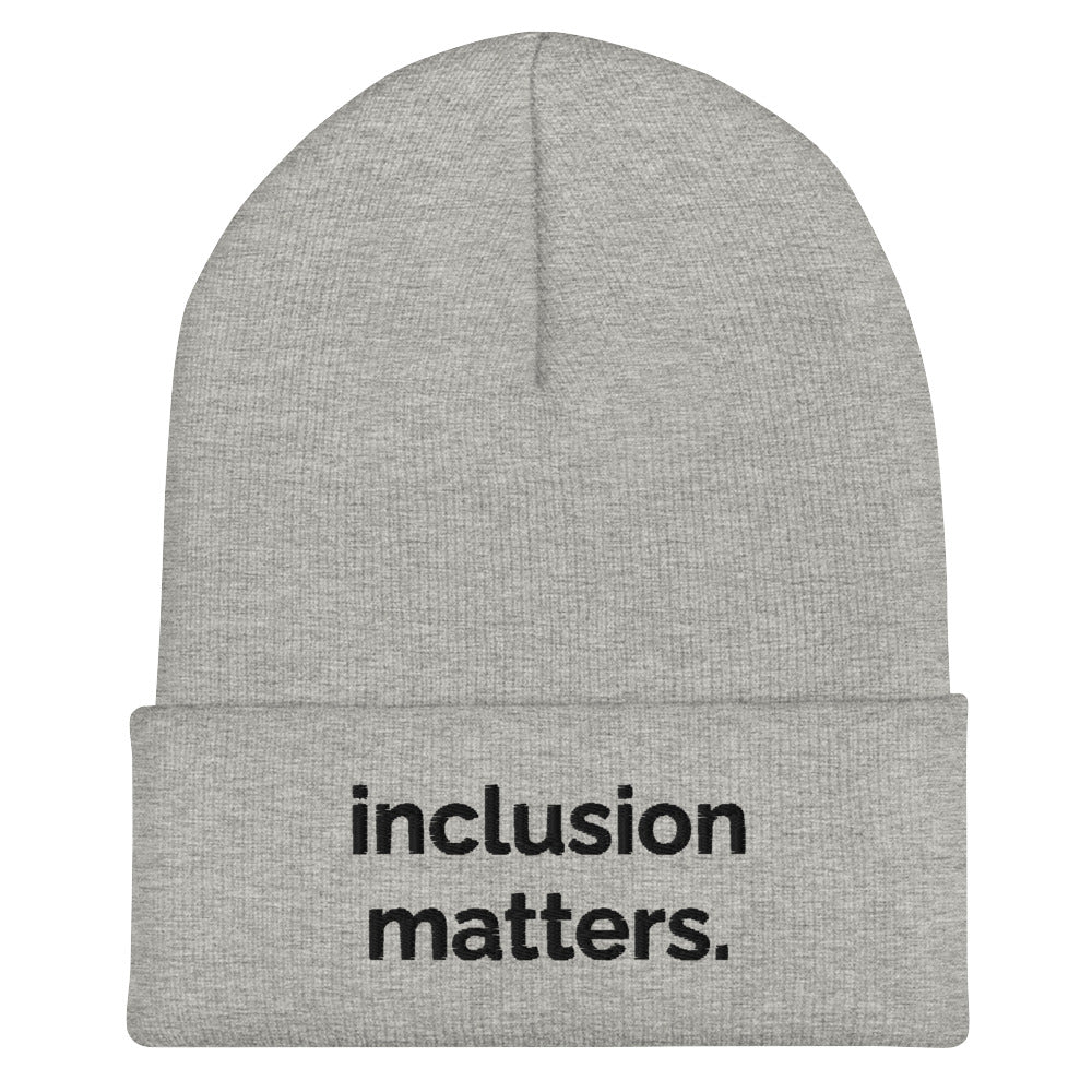 A heather grey Inclusion Matters beanie against a plain white background. On the front of the beanie the phrase, 'Inclusion Matters,' is embroidered on it in black sentence case letters over two lines.