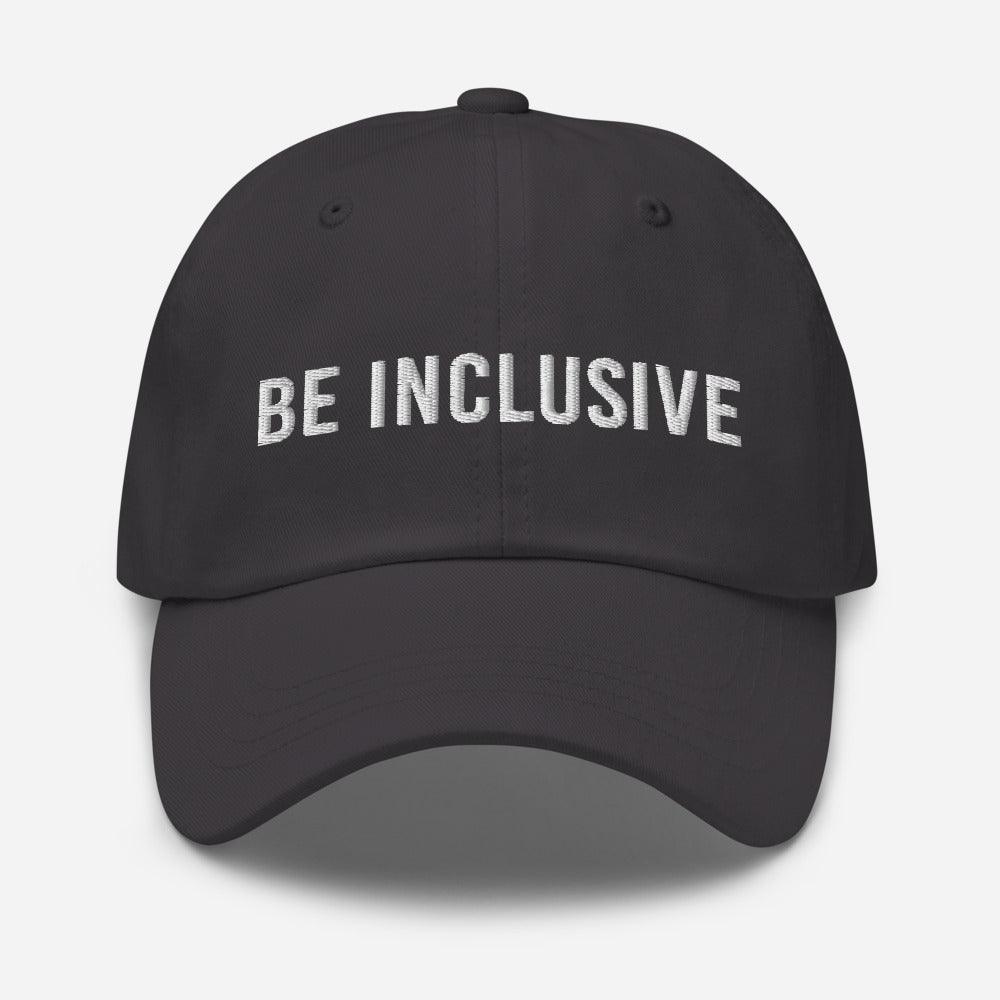 This is a photo of the front of a dark gray cotton twill 'be inclusive cap,' with the phrase "Be Inclusive" embroidered on the front in upper case white letters.