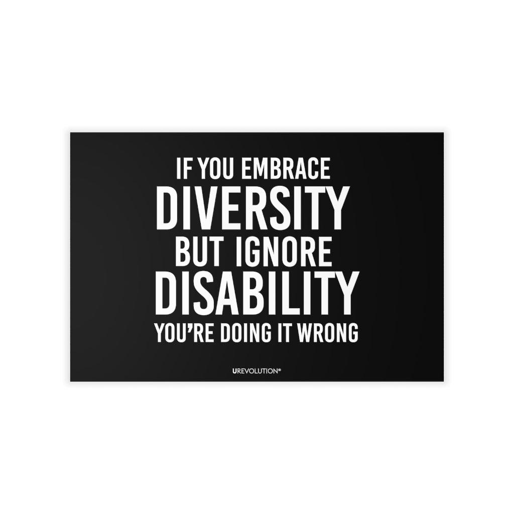 This is a photo of an Embrace Diversity decal. In the middle of the decal is the phrase, printed in white upper case letters, "If you embrace diversity, but ignore disability, you're doing it wrong." The phrase takes up 75% of the decal. At the bottom of the decal, in small white upper case letters, is the brand name URevolution. The size of the decal is 18" x 12".