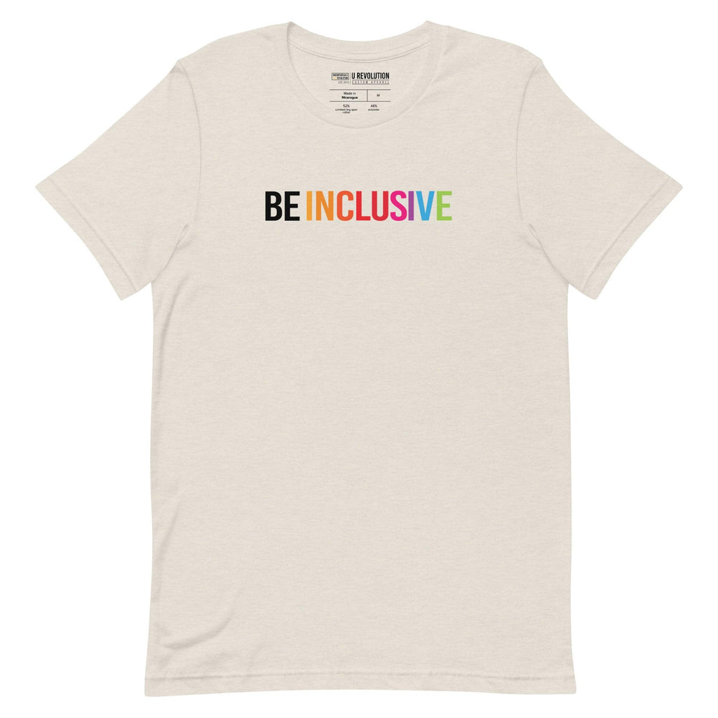 Heather dust Be Inclusive t-shirt with text printed in big caps says "BE INCLUSIVE". BE is in white, and INCLUSIVE is in rainbow colors. Both words are in one line across the top of the shirt.