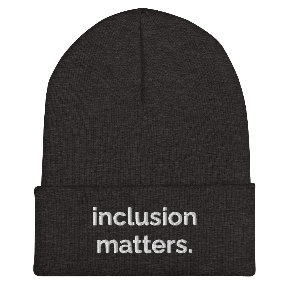 A dark grey Inclusion Matters beanie against a plain white background. On the front of the beanie the phrase, 'Inclusion Matters,' is embroidered on it in white sentence case letters over two lines.