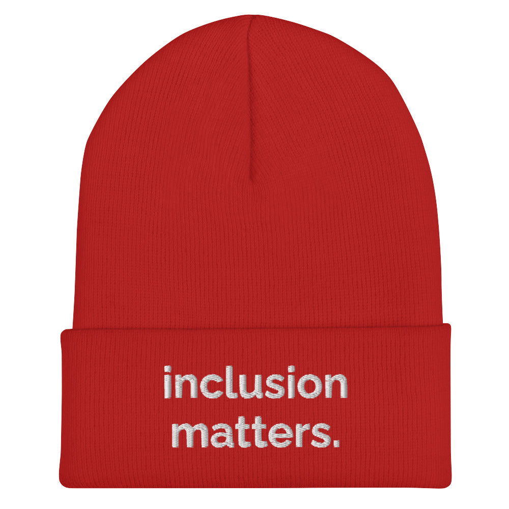 A red Inclusion Matters beanie against a plain white background. On the front of the beanie the phrase, 'Inclusion Matters,' is embroidered on it in white sentence case letters over two lines.