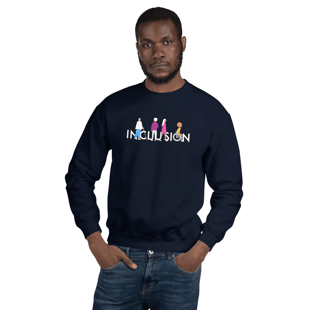 A Black male model is wearing a navy inclusion sweatshirt featuring an original Inclusion icon: The word INCLUSION is written in white upper case letters. Among the letters are four characters: one larger person with glasses and a cane, one person with one arm wearing a turban, one person with long hair and a prosthetic leg, and one person with an afro, seated in a wheelchair leaning forward.