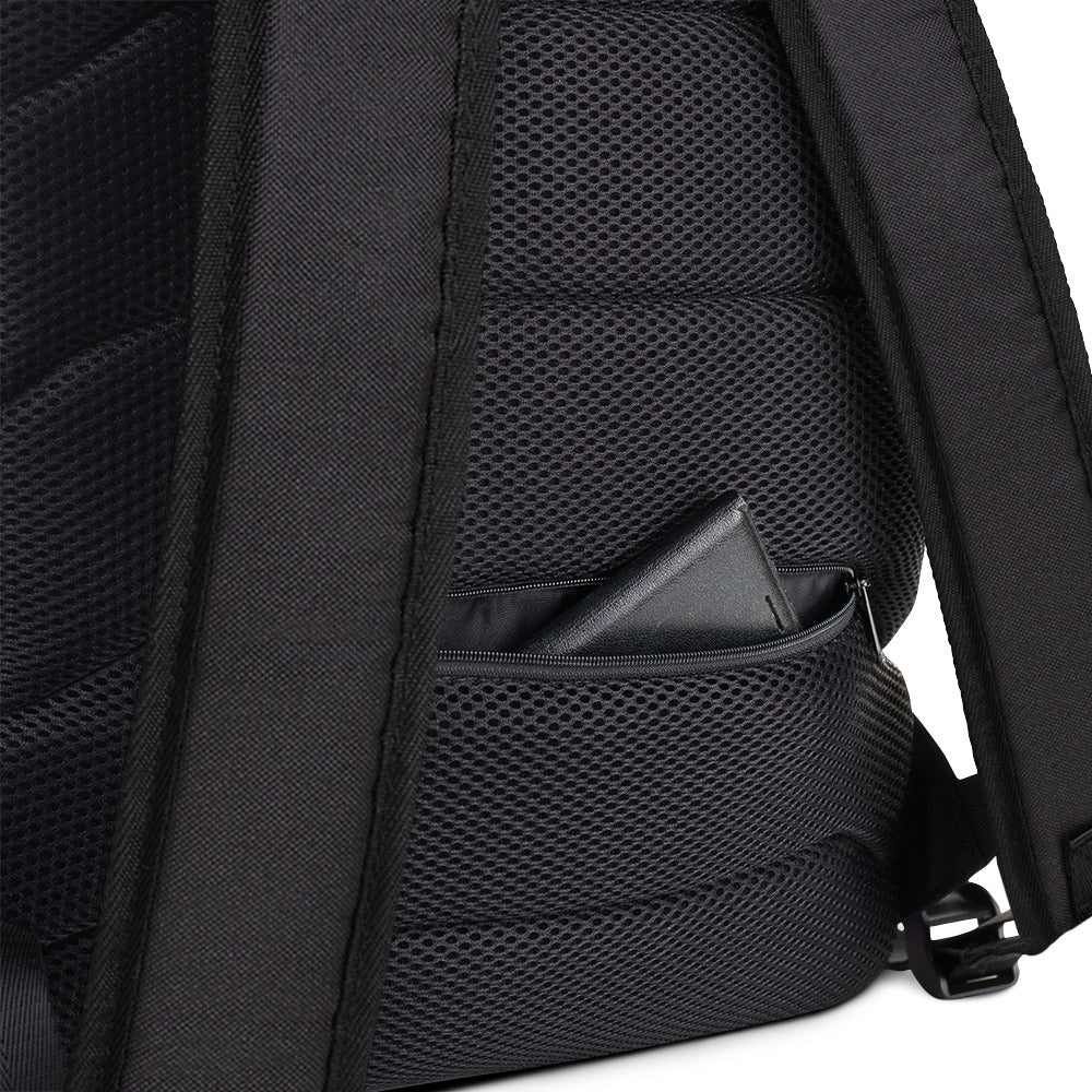 A close up of the padded back of the backpack. At the bottom edge of the backpack is a hidden pocket showing a wallet.