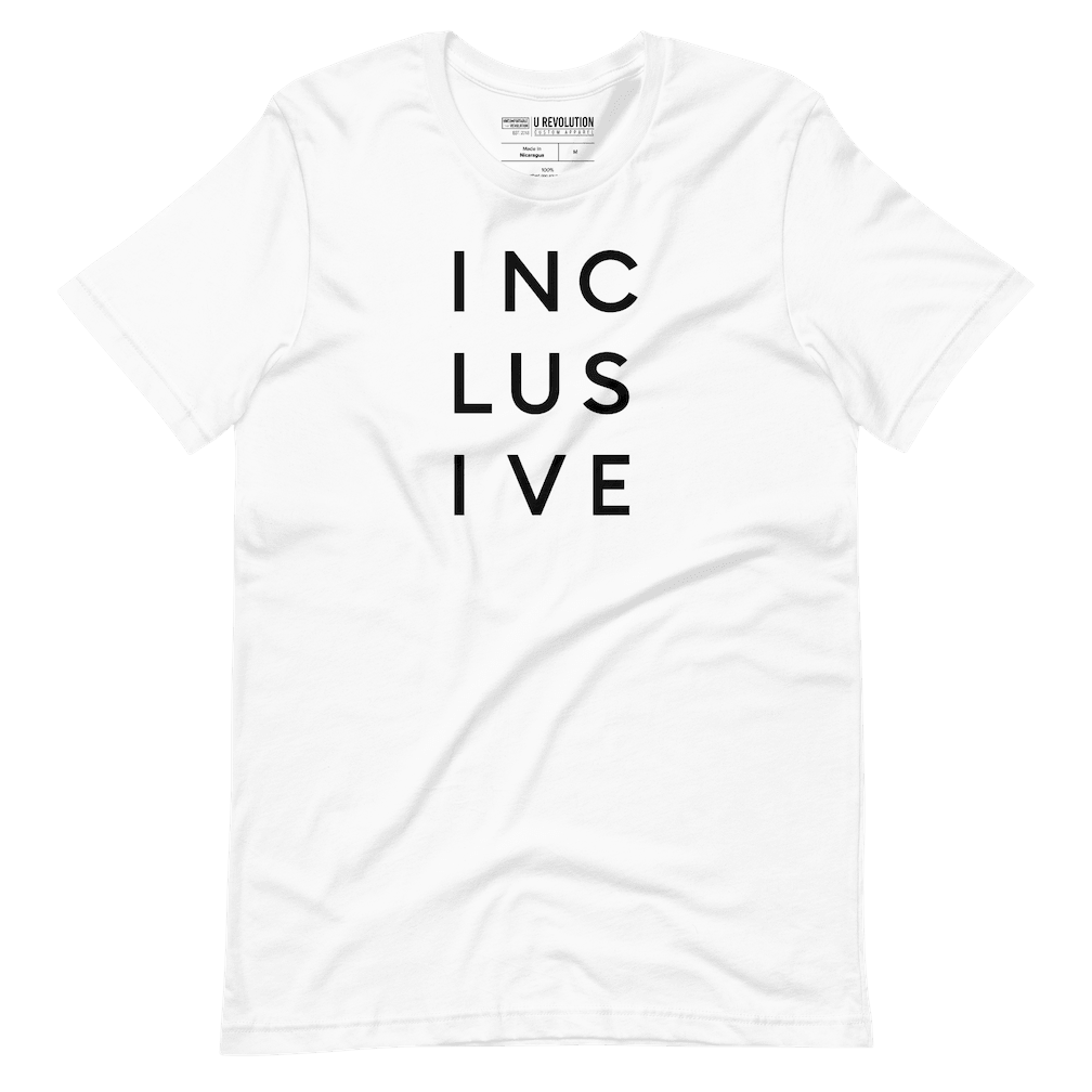 This image is a photo of a white inclusive t-shirt set against a transparent background. This cotton inclusive shirt has the word 'inclusive' in the middle of the chest in upper case black letters over three lines, with three letters on each line: INC LUS IVE. The design takes up the top middle 1/3 of the front of the inclusive t-shirt.