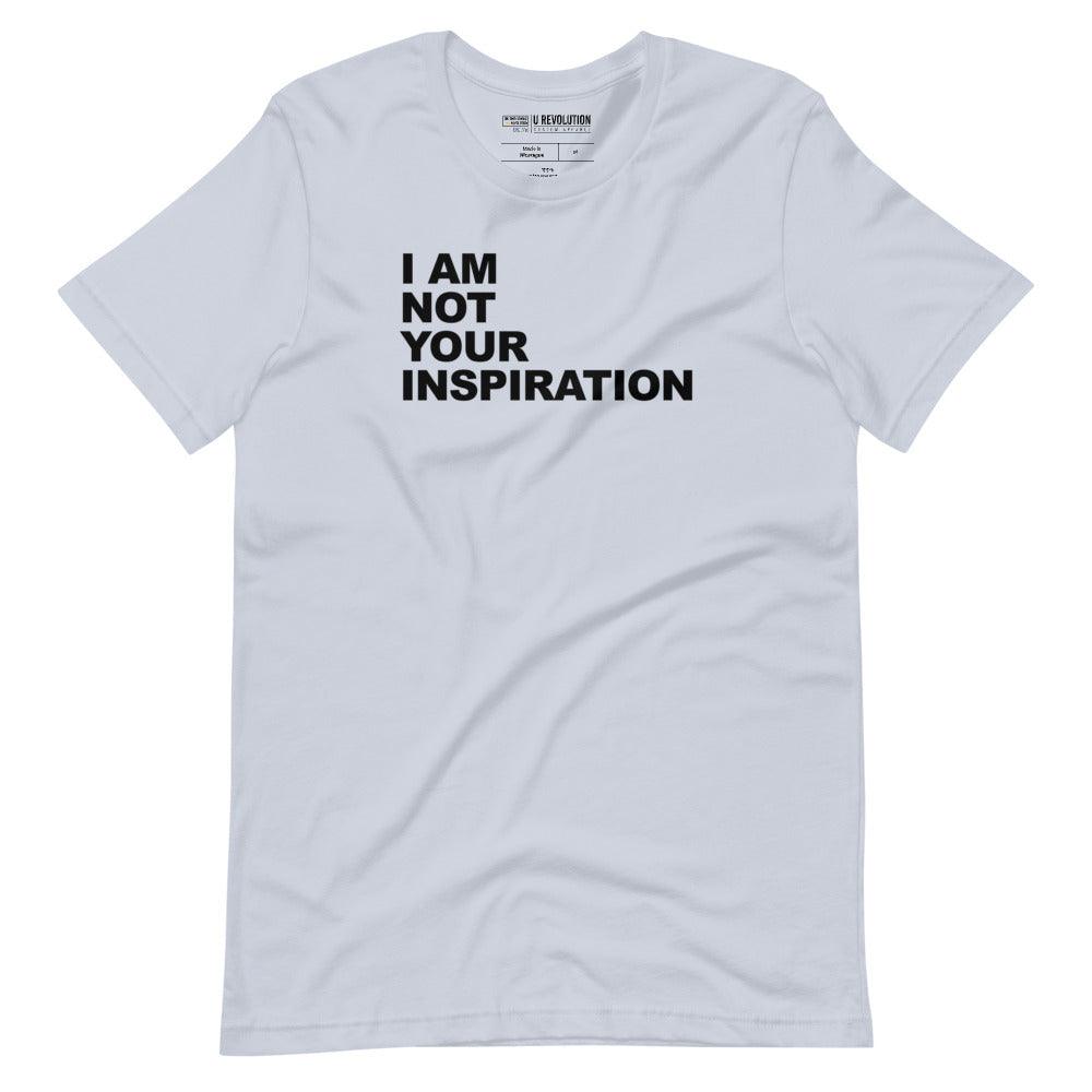 This is a light blue 'I Am Not Your Inspiration" t-shirt. On the top third of the inspiration shirt is the phrase, "I am not your inspiration," printed over four lines in black upper case letters.