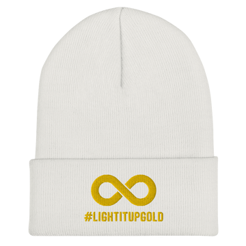 Light it up gold beanie. A thick bold gold infinity symbol is in the middle of a white beanie. Directly under the symbol in upper case letters is the word #LIGHTITUPGOLD