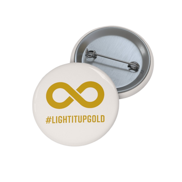 This is a photo of a Light It Up Gold Pin Button. The pin-back button has the word #LightItUpGold printed in large upper case letters beneath a solid line infinity symbol. The symbol and text are colored gold, with the background being soft-white.