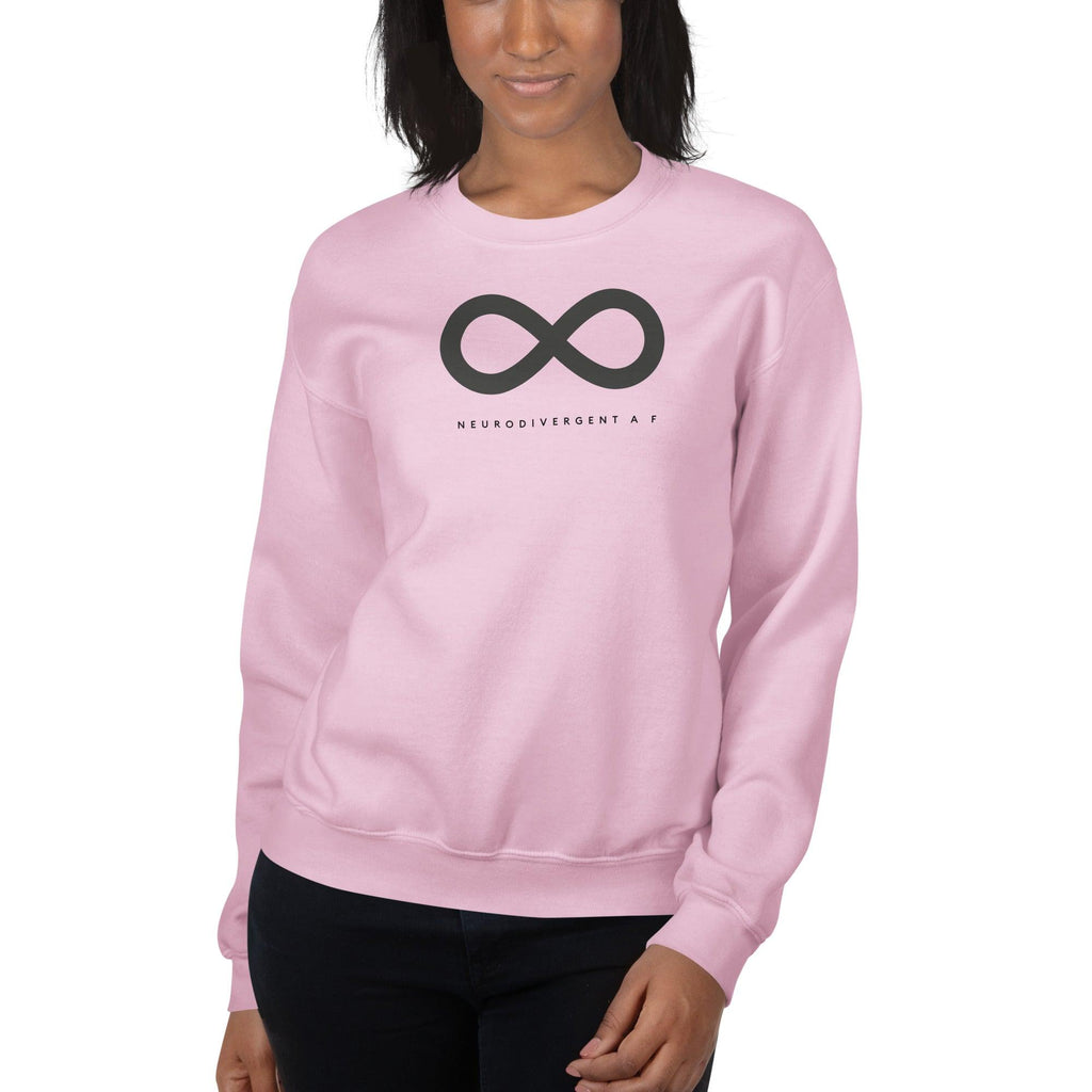 Light pink Neurodivergent AF sweatshirt. There is a black infinity symbol in the top third of the Neurodivergent AF sweatshirt. Under the symbol is the phrase, 'Neurodivergent AF,' in black upper case letters. The sweatshirt is worn by a female model with only her torso visible.