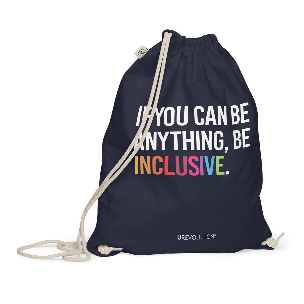 This is a photo of URevolution's navy Be Inclusive organic cotton drawstring bag. In the middle of the drawstring bag, printed in large white upper case letters, is the phrase, 'If you can be anything, be inclusive.' The word 'inclusive' is in the color of the rainbow. At the bottom edge of the bag is the word, URevolution, printed in small white upper case letters.