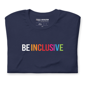 Folded navy Be Inclusive t-shirt with text printed in big caps says "BE INCLUSIVE". BE is in white, and INCLUSIVE is in rainbow colors. Both words are in one line across the top of the shirt.