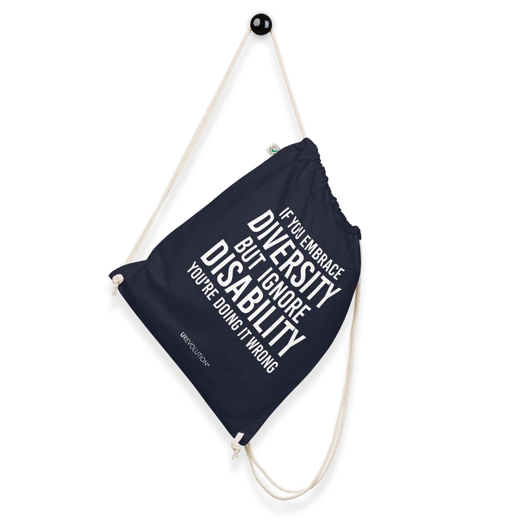 a navy Embrace Diversity organic cotton drawstring bag. The middle of the drawstring bag features the phrase, printed in large white upper case letters, "If you embrace diversity but ignore disability, you're doing it wrong." The phrase fills 80% of the bag. 