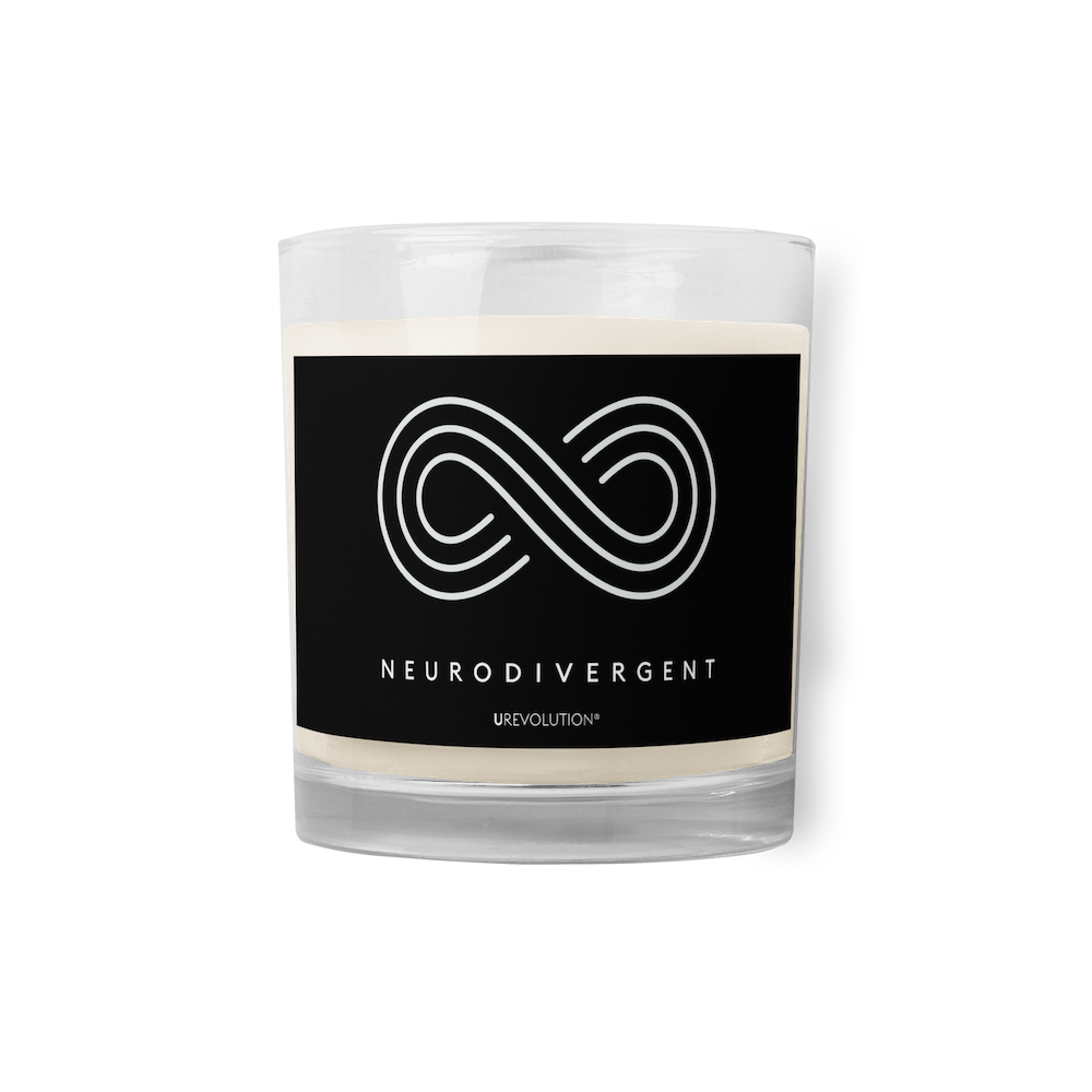 Neurodivergent candle by URevolution. This is a photo of a candle in a glass jar with a black label. In the middle of the black label is a three-ringed infinity symbol with the word 'neurodivergent' in white upper case letters beneath the symbol. 