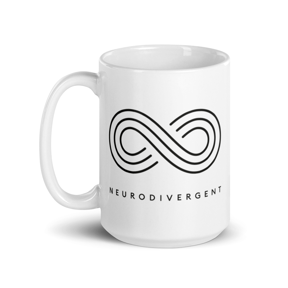 White 15oz Neurodivergent Mug . In the middle of the tee is an elegant black infinity symbol consisting of three thin black lines. Just below the infinity symbol is the word Neurodivergent in elegant upper case black letters.