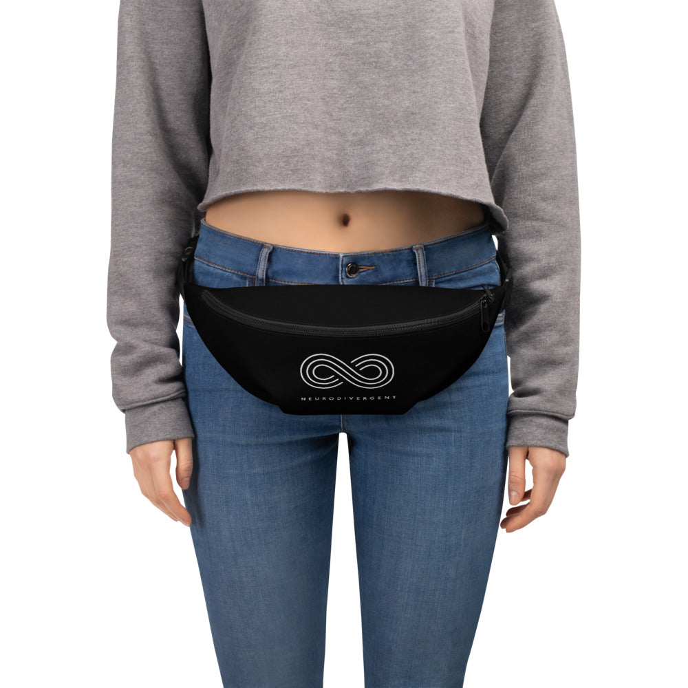 This is a photo of a black Neurodivergent waist bag. On the front of the waist bag is an elegant white infinity symbol consisting of three thin white lines. Just below the symbol is the word Neurodivergent in elegant upper case white letters. The pack is worn across the waist of a person.