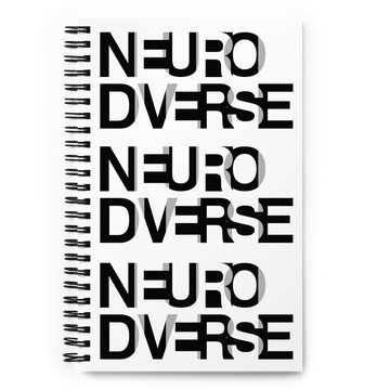 The cover of a Neurodiverse Notebook has a fabric pattern with the word NEURODIVERSE printed all over in repeating black and white alternating letters. The letters are printed in large uppercase letters that overlap.