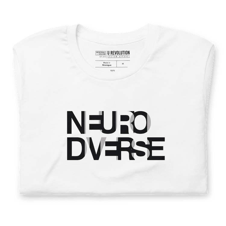 This is a white NeuroDiverse shirt that has the text NEURODIVERSE printed in large alternating black and white letters on the front, taking up about one-third of the shirt surface.  The t-shirt is folded.